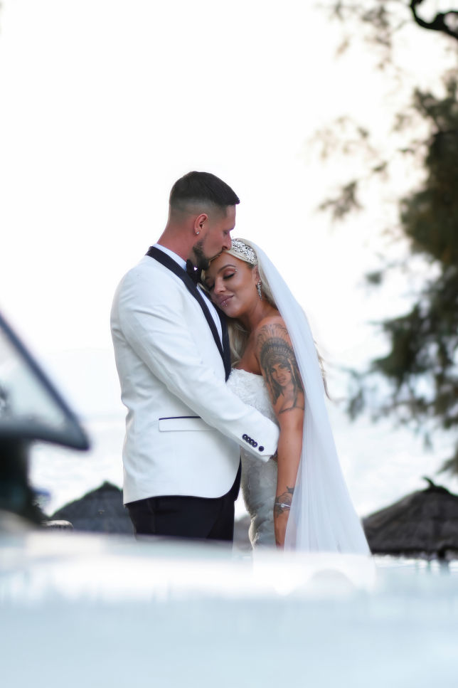 Groom placing the ring on the brides finger  wedding