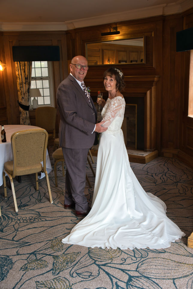 Relaxed portrait of newlyweds at The Stanneylands Hotel wedding venue Wilmslow